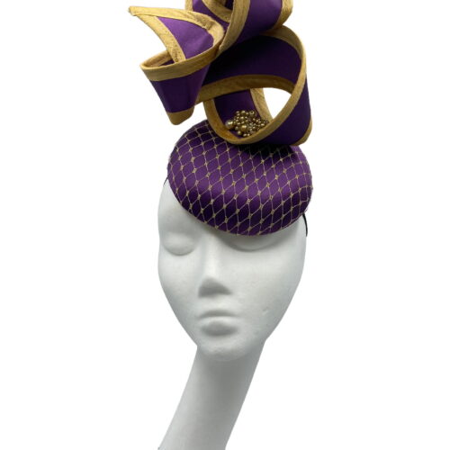 Cadbury purple hat with purple twist with gold trim, finished with a beaded detail to the centre of the twist.